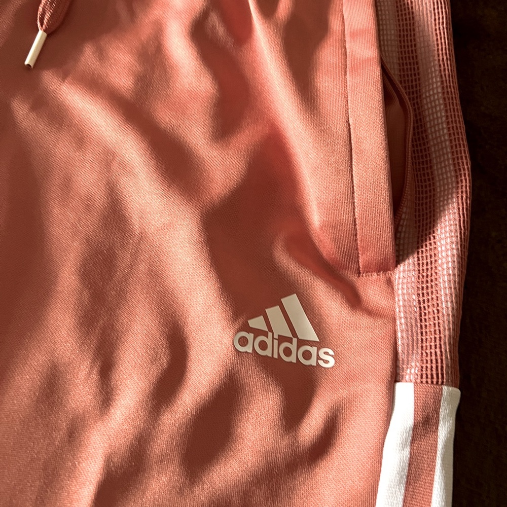 Adidas sweatpants tapered leg with zippered calf. Size Medium.